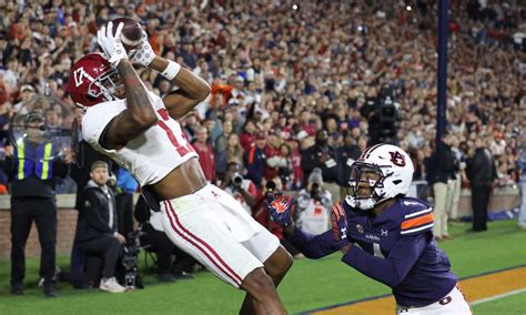 Jalen Milroe and Isaiah Bond rescued No. 8 Alabama’s College Football Playoff hopes, connecting for a last-minute touchdown on fourth-and-goal from the 31 to beat Auburn 27-24.